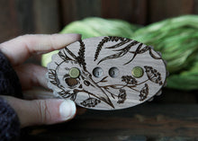 Load image into Gallery viewer, Raven Skull Wood Row Counter with Forest Plants &amp; Yarrow
